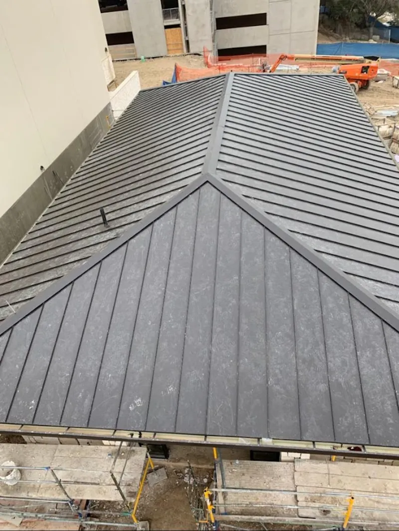 Commercial metal roof construction with crane equipment in McMinnville